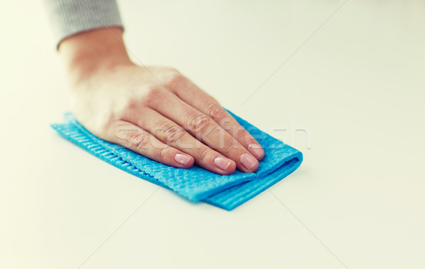 close up of hand cleaning table surface with cloth Stock photo © dolgachov