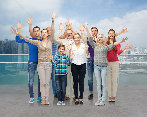 group of smiling people waving hands Stock photo © dolgachov