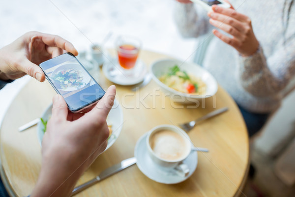 close up of couple picturing food by smartphone Stock photo © dolgachov