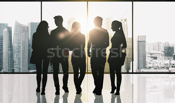 people silhouettes over window and city background Stock photo © dolgachov