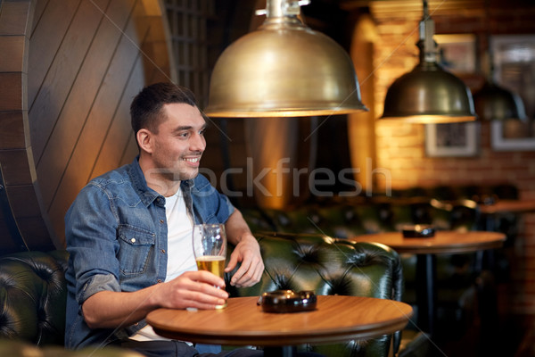 happy man drinking draft beer at bar or pub Stock photo © dolgachov