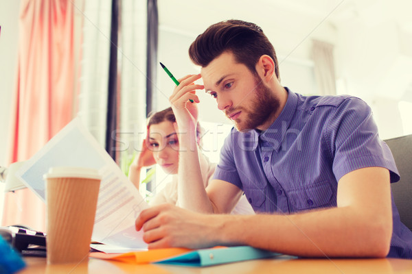 creative team with computer and papers in office Stock photo © dolgachov