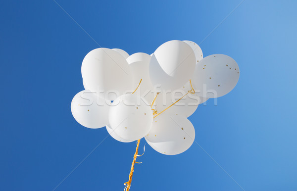 close up of white helium balloons in blue sky Stock photo © dolgachov