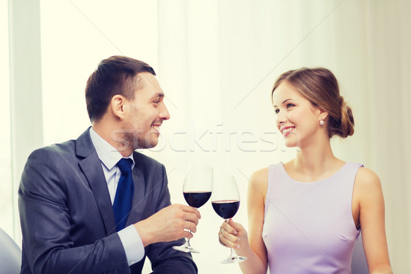 young couple with glasses of wine at restaurant Stock photo © dolgachov