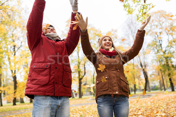 happy young couple throwing autumn leaves in park Stock photo © dolgachov