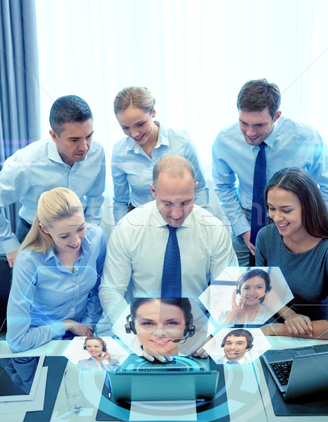 smiling business people with laptop in office Stock photo © dolgachov