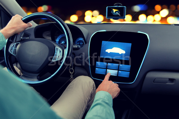 close up of man driving car with on board computer Stock photo © dolgachov