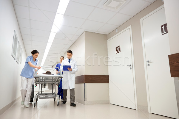 medics and patient on hospital gurney at emergency Stock photo © dolgachov