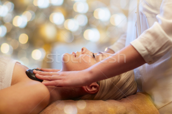 close up of woman having hot stone massage in spa Stock photo © dolgachov