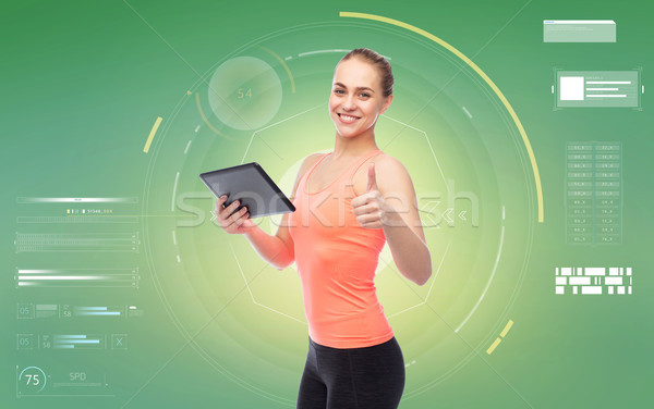 happy smiling sportive young woman with tablet pc Stock photo © dolgachov