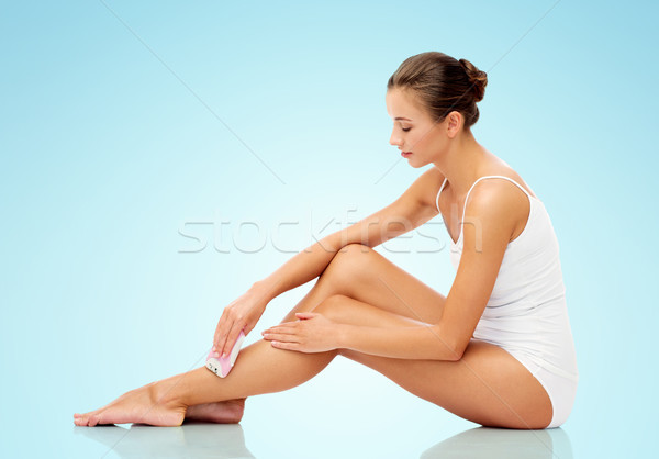 woman with epilator removing hair on legs Stock photo © dolgachov