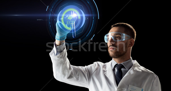 scientist with test tube and virtual projection Stock photo © dolgachov
