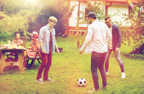 Fericit prietenii joc fotbal vară grădină Imagine de stoc © dolgachov