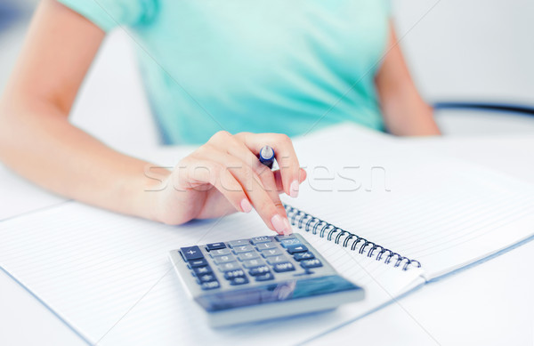 businesswoman working with calculator in office Stock photo © dolgachov