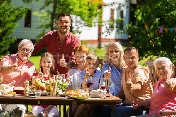 happy family having dinner or summer garden party Stock photo © dolgachov