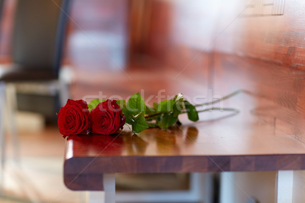 red roses on bench at funeral in church Stock photo © dolgachov