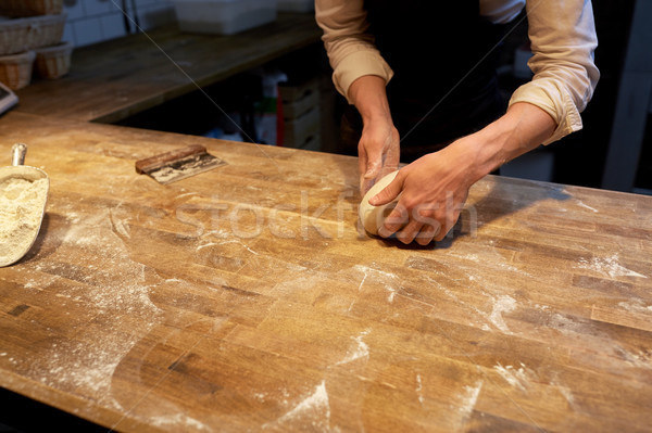 baker making bread dough at bakery kitchen Stock photo © dolgachov