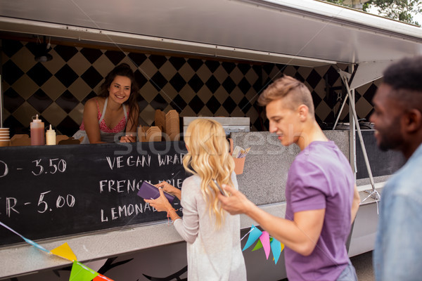 happy customers queue at food truck Stock photo © dolgachov