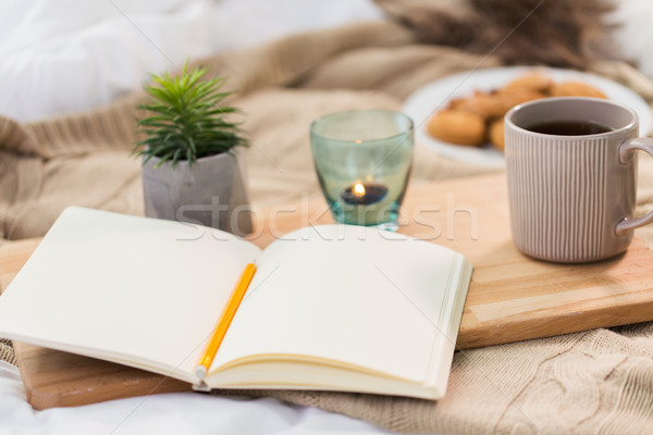 diary, tea and candle in holder at home Stock photo © dolgachov