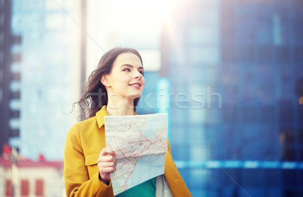 happy young woman traveling with map in city Stock photo © dolgachov