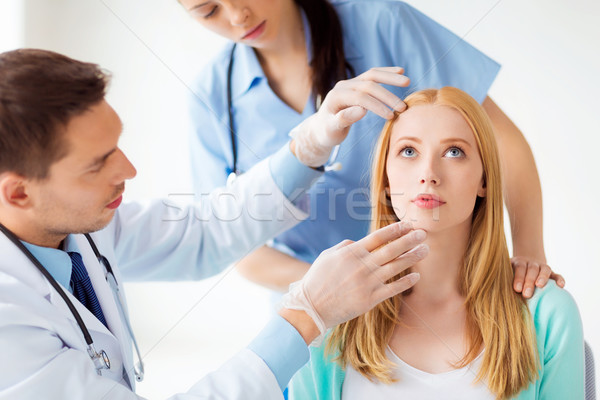 male plastic surgeon with patient Stock photo © dolgachov