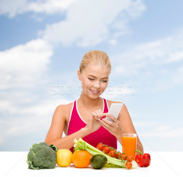 woman with vegetables pointing at smartphone Stock photo © dolgachov