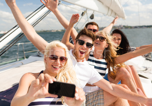 smiling friends sitting on yacht deck Stock photo © dolgachov