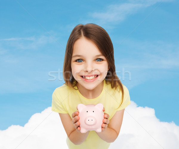 beautiful little girl with piggy bank Stock photo © dolgachov