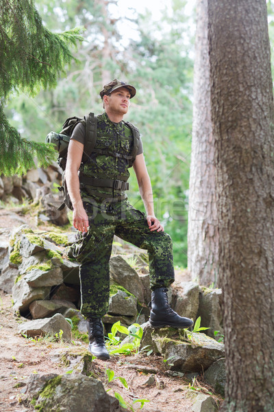 Stock photo: young soldier with backpack in forest