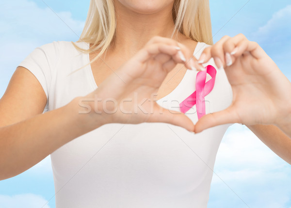 close up of woman and pink cancer awareness ribbon Stock photo © dolgachov