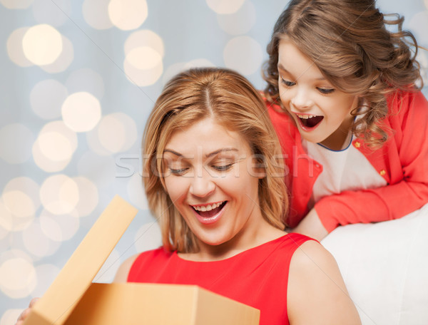 happy mother and daughter opening gift box Stock photo © dolgachov