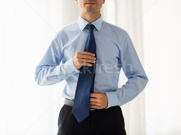 close up of man in shirt adjusting tie on neck Stock photo © dolgachov