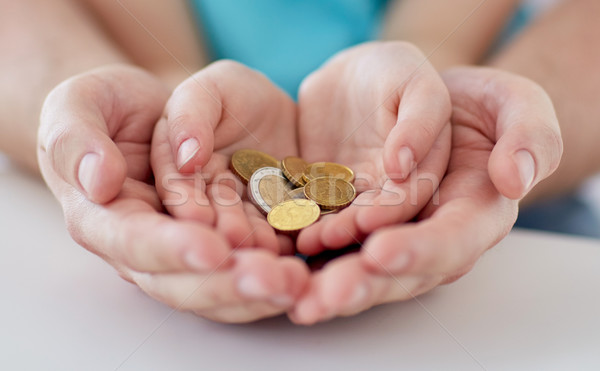 close up of family hands holding euro money coins Stock photo © dolgachov