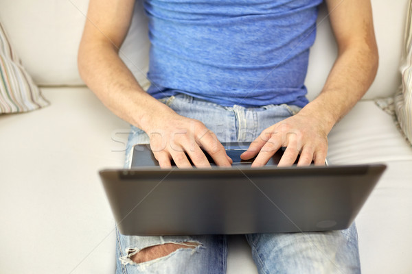 close up of man typing with laptop at home Stock photo © dolgachov