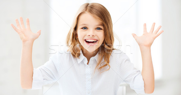 Surpreendido risonho menina as mãos levantadas educação escolas Foto stock © dolgachov