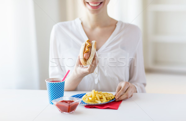 close up of woman eating hotdog and french fries Stock photo © dolgachov