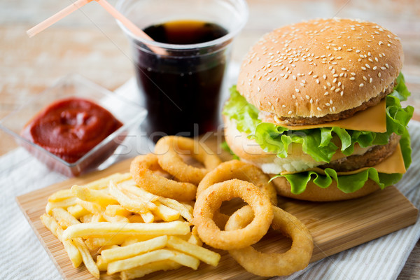 close up of fast food snacks and drink on table Stock photo © dolgachov