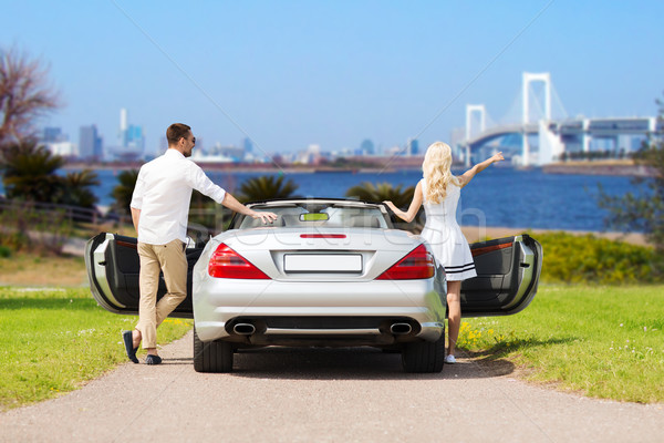 happy man and woman near cabriolet car in tokyo Stock photo © dolgachov