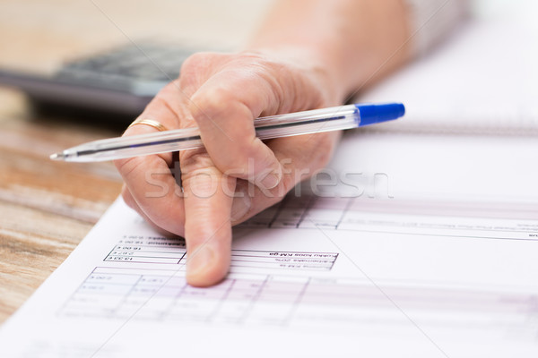 close up of senior woman hand checking bill Stock photo © dolgachov