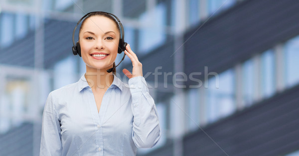 helpline operator in headset over business center Stock photo © dolgachov