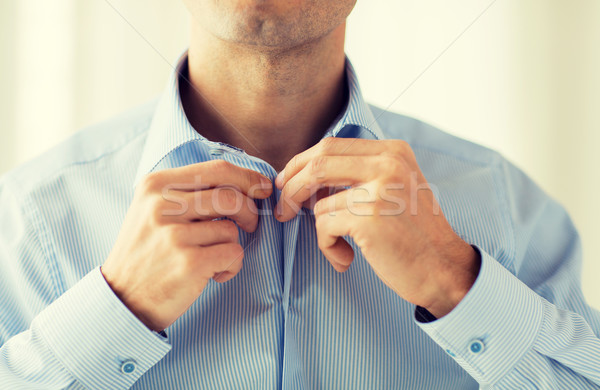 close up of man in shirt dressing  Stock photo © dolgachov