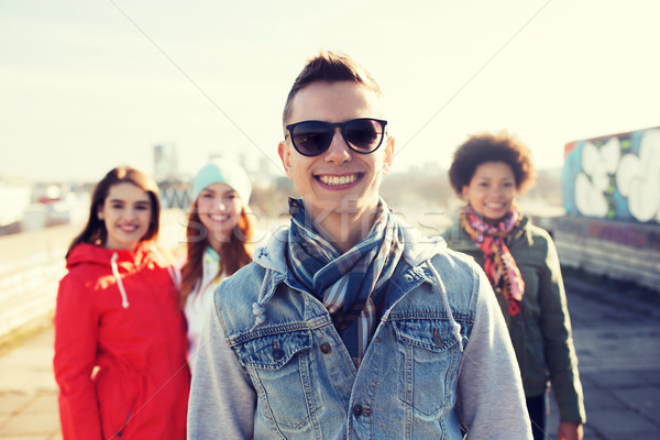 group of happy teenage friends on city street Stock photo © dolgachov