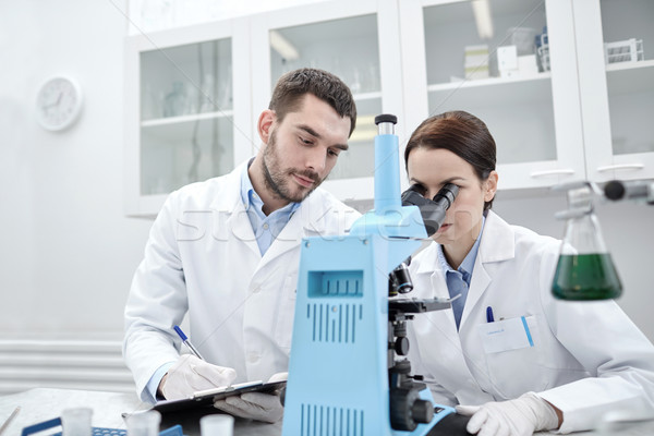 young scientists making test or research in lab Stock photo © dolgachov