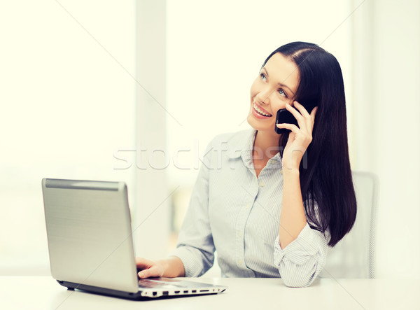 businesswoman with laptop and cell phone Stock photo © dolgachov