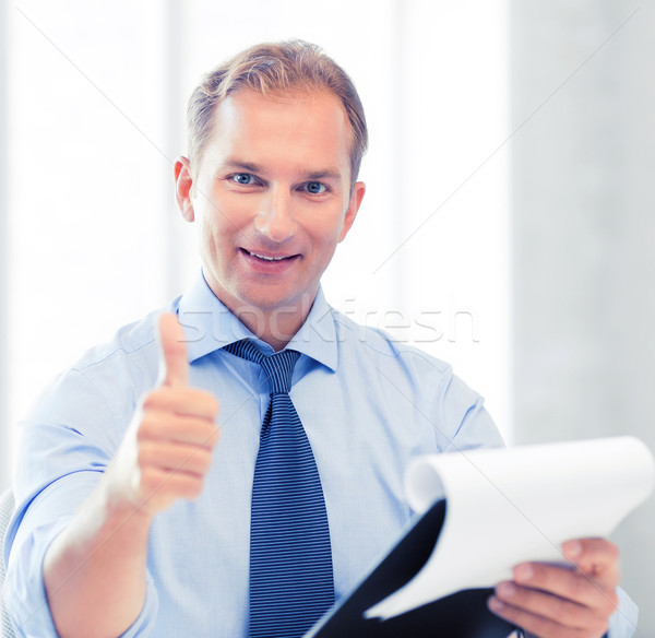 businessman with papers showing thumbs up Stock photo © dolgachov