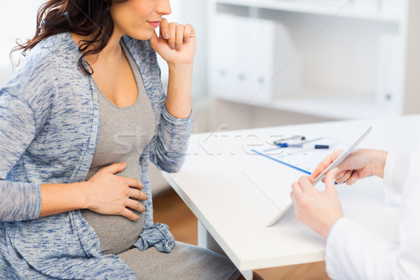 close up of doctor with tablet and pregnant woman Stock photo © dolgachov