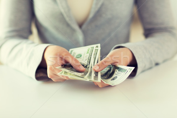 close up of woman hands counting us dollar money Stock photo © dolgachov