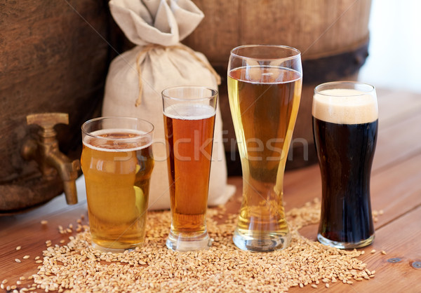 Stock photo: close up of beer barrel, glasses and bag with malt