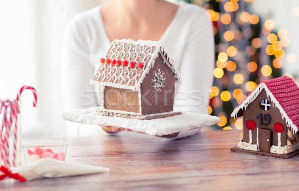 close up of woman showing gingerbread house Stock photo © dolgachov