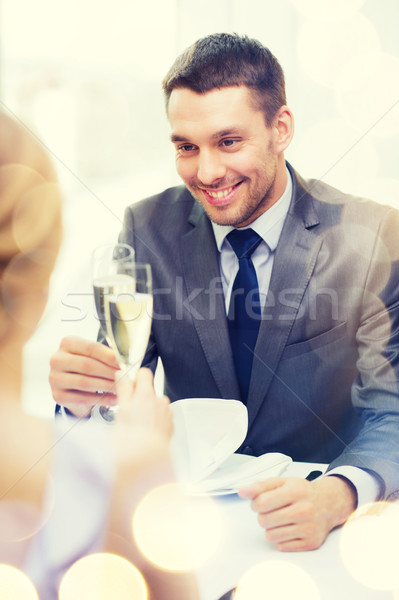 couple with glasses of champagne at restaurant Stock photo © dolgachov